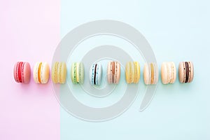 colorful macarons neatly aligned on pastel surface