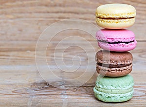 Colorful macarons on rustic wood