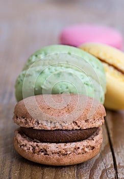 Colorful macarons on rustic wood