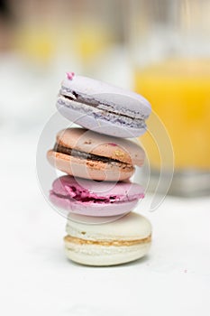 Colorful macarons on the table blur outdoor background.