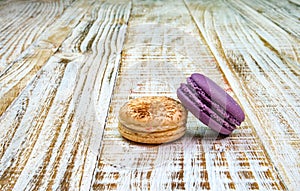 Colorful macarons on vintage pastel background. Macaron or Macaroon is sweet meringue-based confection