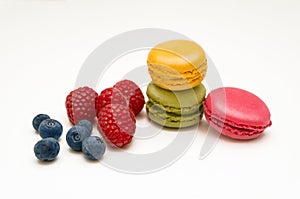 Colorful macaroon coolies with raspberry and blueberry berries