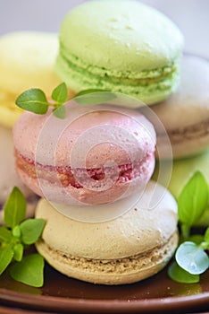 Colorful macaroons on brown plate