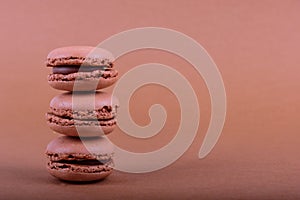 Colorful macaroons cake, sweet macaroon on brown background, food background
