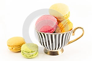 Colorful Macaroons in a Cup Isolated on White Background