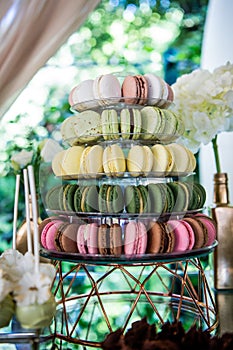 Colorful macaroons. Dessert table for a party. Candy bar. Rich thematic wedding candy bar high variety of sweets