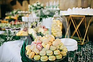 Colorful macaroons  at dessert table at wedding party.  Sweet food photo