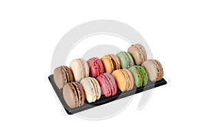 Colorful macaroons traditional french biscuit in a rows black box on white background and path. macarons with many tasty as coffee