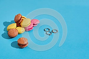 Colorful macaroons. Wedding rings. Marriage proposal. The concept of Valentine`s Day photo