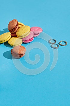 Colorful macaroons. Wedding rings. Marriage proposal. The concept of Valentine`s Day photo
