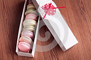 Colorful macaroons in the white present box