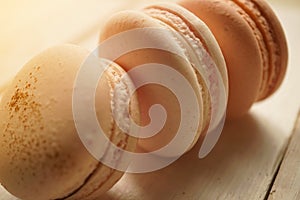 Colorful macaroons on white wooden background