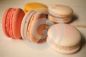 Colorful macaroons on white wooden background