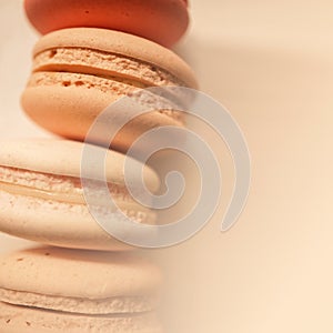 Colorful macaroons on white wooden background