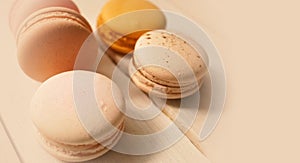 Colorful macaroons on white wooden background