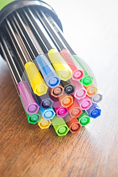 Colorful magic pens on wooden table