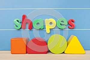 Colorful magnetic letter spelling shapes.