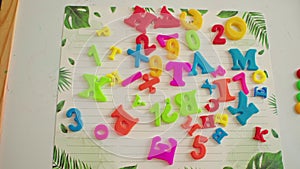 Colorful magnetic letters and numbers on whiteboard. Early learning, literacy, and numeracy concept. Design for