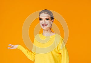 Colorful makeup woman red lips in yellow clothes on color happy summer fashion background manicured nails