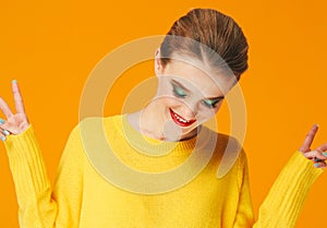 Colorful makeup woman red lips in yellow clothes on color happy summer fashion background manicured nails