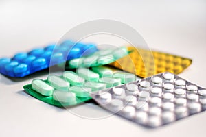 Colorful Many pills and tablets isolated on white background, pharmaceuticals antibiotic drug capsule pills in package.