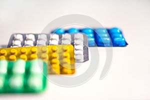 Colorful Many pills and tablets isolated on white background, pharmaceuticals antibiotic drug capsule pills in package.