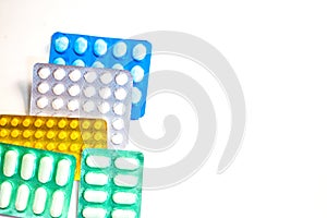 Colorful Many pills and tablets isolated on white background, pharmaceuticals antibiotic drug capsule pills in package.