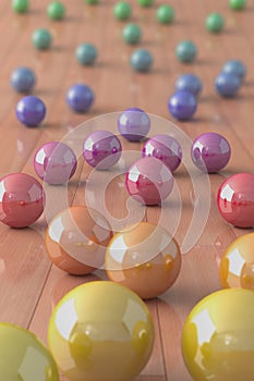 Colorful marble balls on a parquet floor