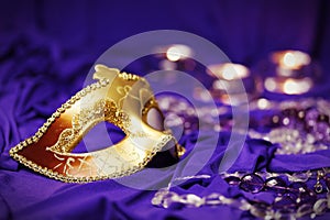 Colorful Mardi Gras or Carnival masks group on a purple background.