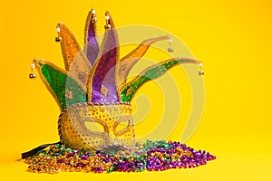 Colorful Mardi Gras or venetian mask on yellow