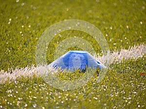 Colorful mark in football playfield. White line marks painted on artificial green turf background.