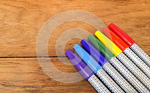 Colorful Marker Pens in Rainbow Order on Wooden Table