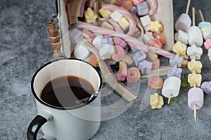 Colorful marshmallow and jellybeans with a cup of tea