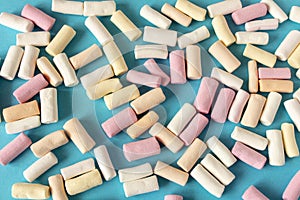 Colorful marshmallows on a blue background. Close-up. Selective focus