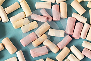 Colorful marshmallows on a blue background. Close-up. Selective focus