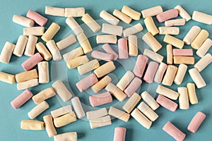 Colorful marshmallows on a blue background. Close-up. Selective focus