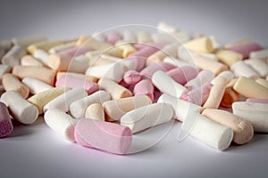 Colorful marshmallows on a light background. Close-up. Selective focus