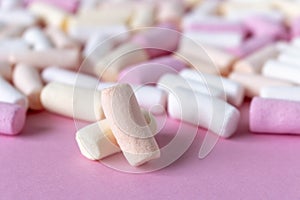 Colorful marshmallows on a pink background. Close-up. Selective focus