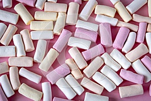 Colorful marshmallows on a pink background. Close-up. Selective focus