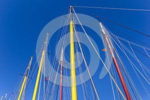 Colorful masts of sailing ships in the harbor of Harlingen