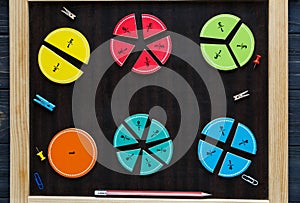 Colorful math fractions and apples as a sample on brown wooden background or table. interesting math for kids. Education