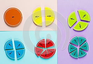 Colorful math fractions on the pink blue violet bright backgrounds. Interesting math for kids. Education, back to school concept.