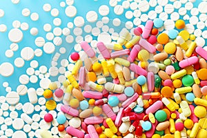 Colorful medecine pills on a blue background