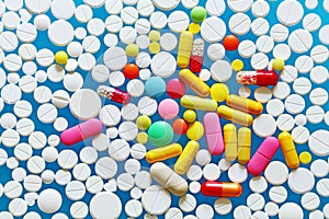 Colorful medecine pills on a blue background