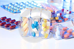 Colorful medical capsules in bottle