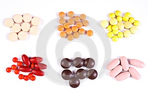 Colorful medical pills and capsules on white background, health care concept