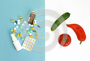 Colorful medical pills and natural fruits, cucumber, red a tomato and pepper