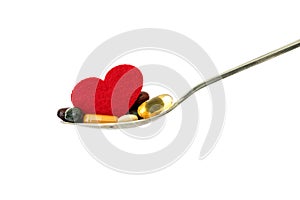 The colorful medical supplement and drug pills with red heart in