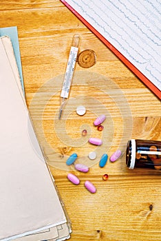 Colorful medical tablets and pills on doctor's office desk