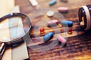 Colorful medical tablets and pills on doctor's office desk